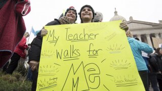 A student holds a protest sign