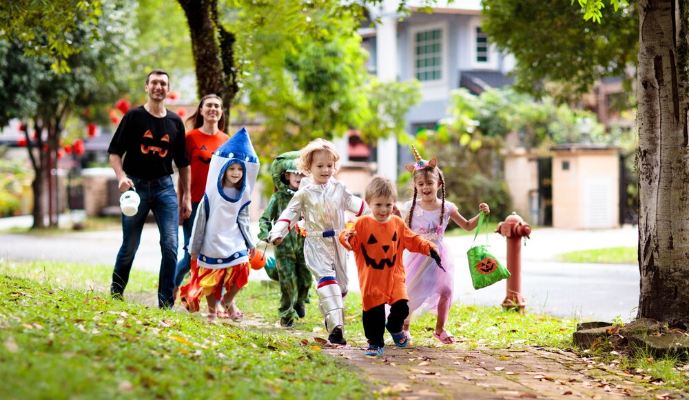 Child,In,Halloween,Costume.,Asian,And,Caucasian,Kids,And,Parents
