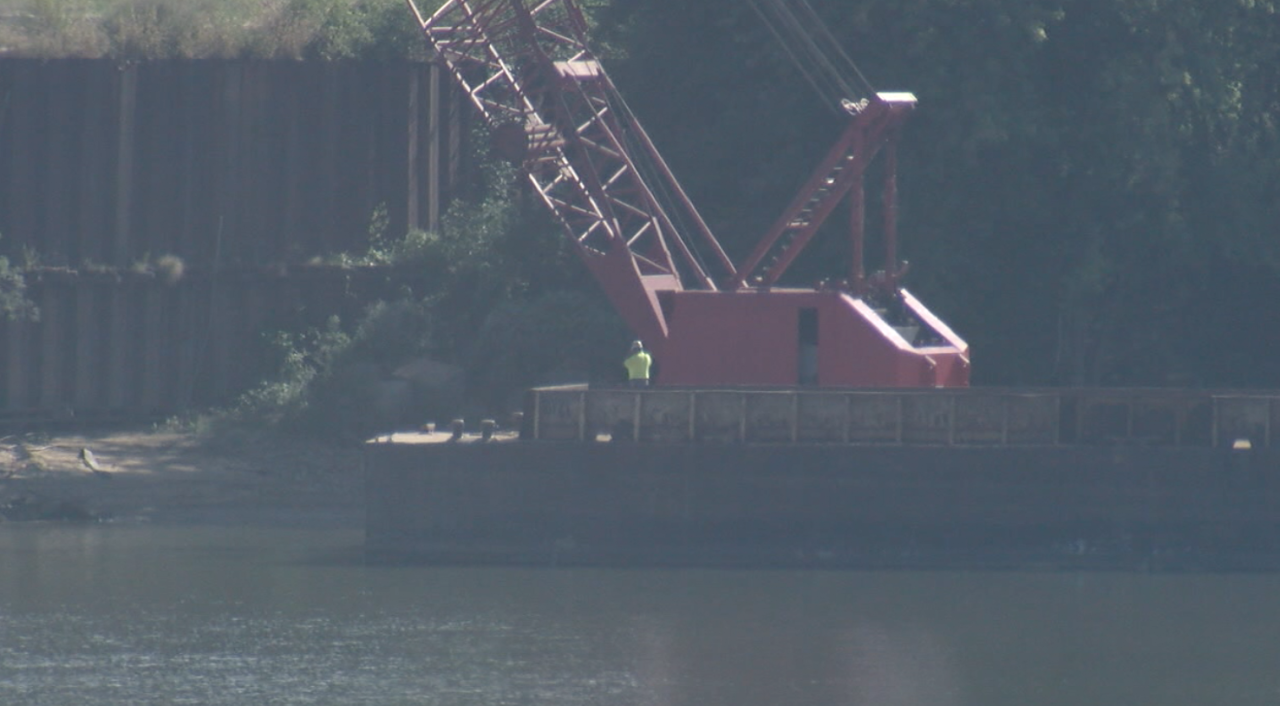 Crews work on barge-mounted crane at Beckjord on Sept. 17, 2021. 