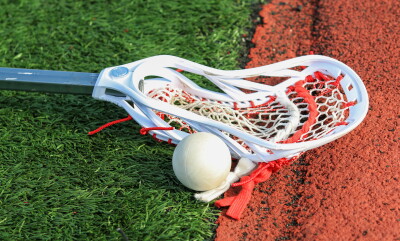 Lacrosse,Stick,On,The,Turf,Next,To,A,Ball,Close