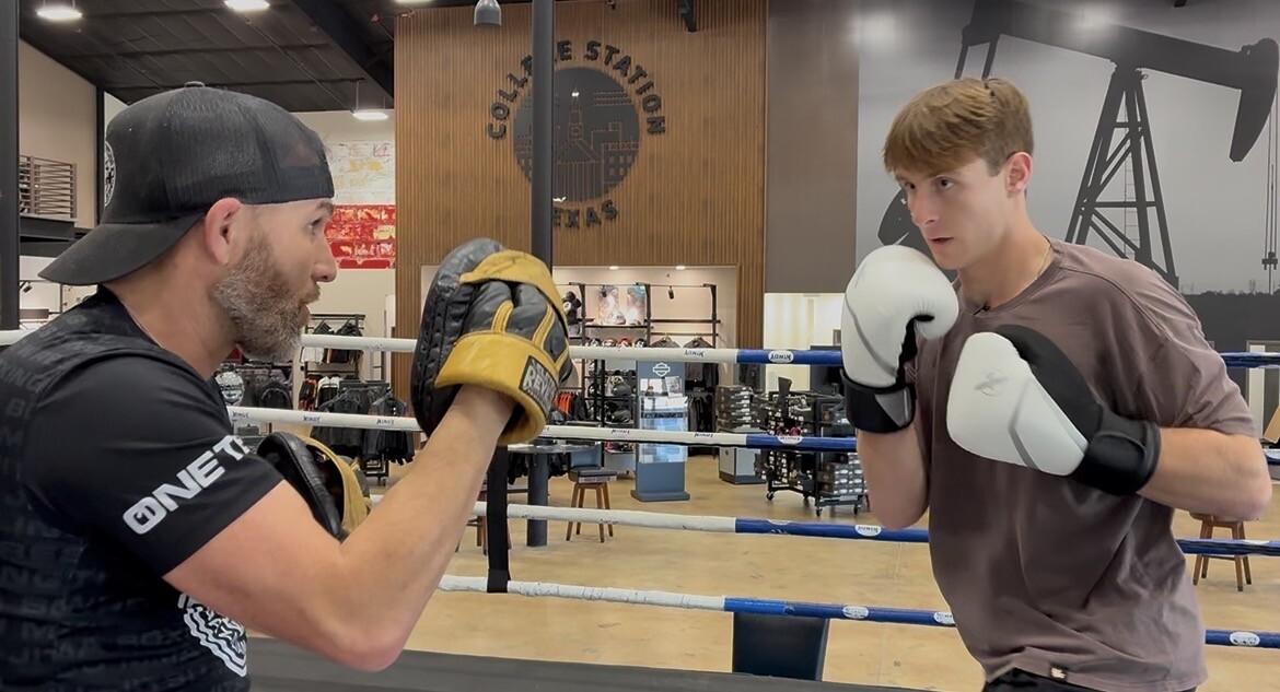 Photo by: Jessica Poole

Jackson Wolff hits mitts with coach Bobby Powers before Aggie Fight Night