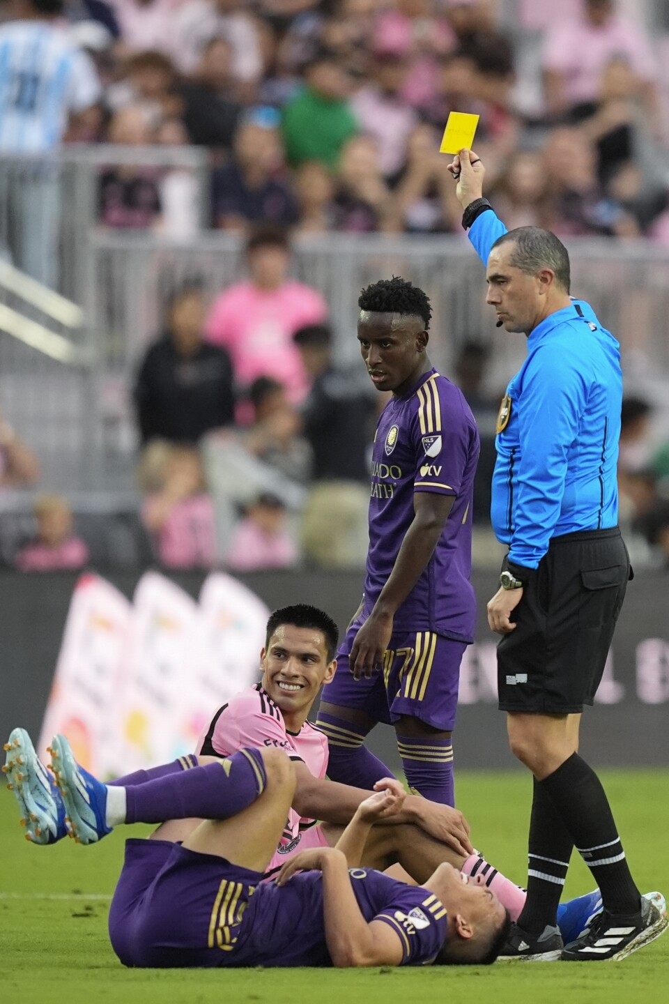 Referee Jaime Herrera raises yellow card to Inter Miami midfielder Diego Gomez after he fouled Orlando City midfielder Cesar Araujo during second half, March 2, 2024