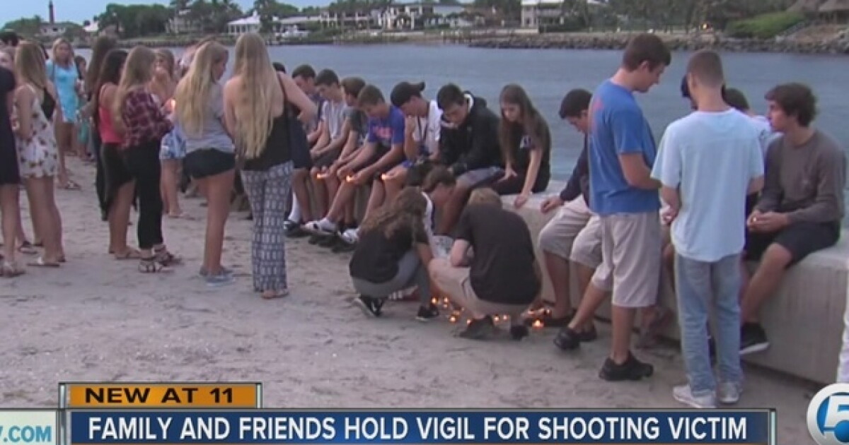 Friends, family hold vigil for slain teen
