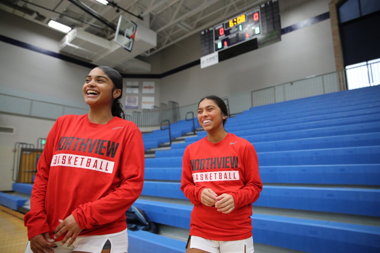 Point guard Miley Vasquez (right) and teammate share a laugh.