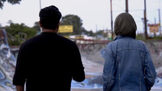 Shaffwan Ahmed and Noor Tagouri walk away in Hamtramck, Michigan.