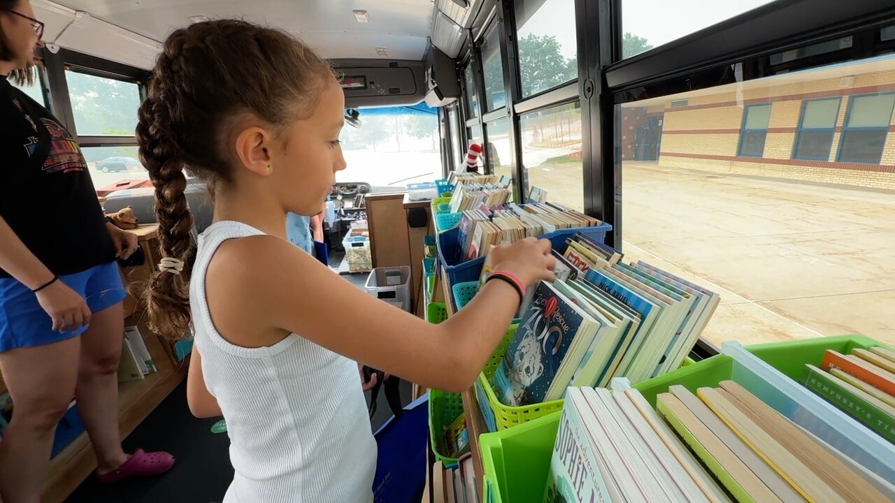 Girl picking out books.jpg