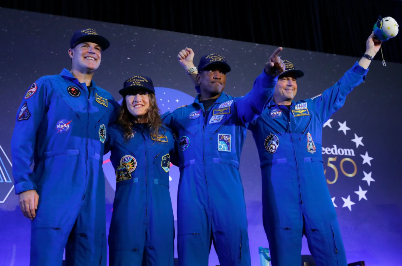 The Artemis II crew, from left, Jeremy Hansen, Christina Koch, Victor Glover and Reid Wiseman come to the center stage at the end of a crew return event Saturday, April 11, 2026, at Ellington Field in Houston.