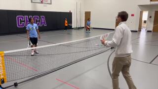 Cam plays tennis with the youth