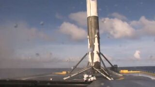 A Falcon 9 rocket sitting atop SpaceX's floating barge.