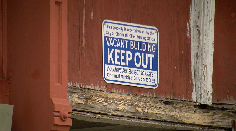 Cincinnati officials say the corner of Vine and Green streets in Over-the-Rhine is one of the most dangerous in the city, and are targeting many building owners with public nuisance complaints. This sign is on a building at 8 Green St.