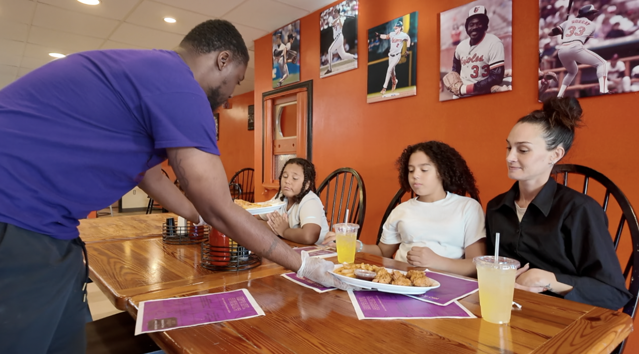 One of the mothers and her kids getting a meal