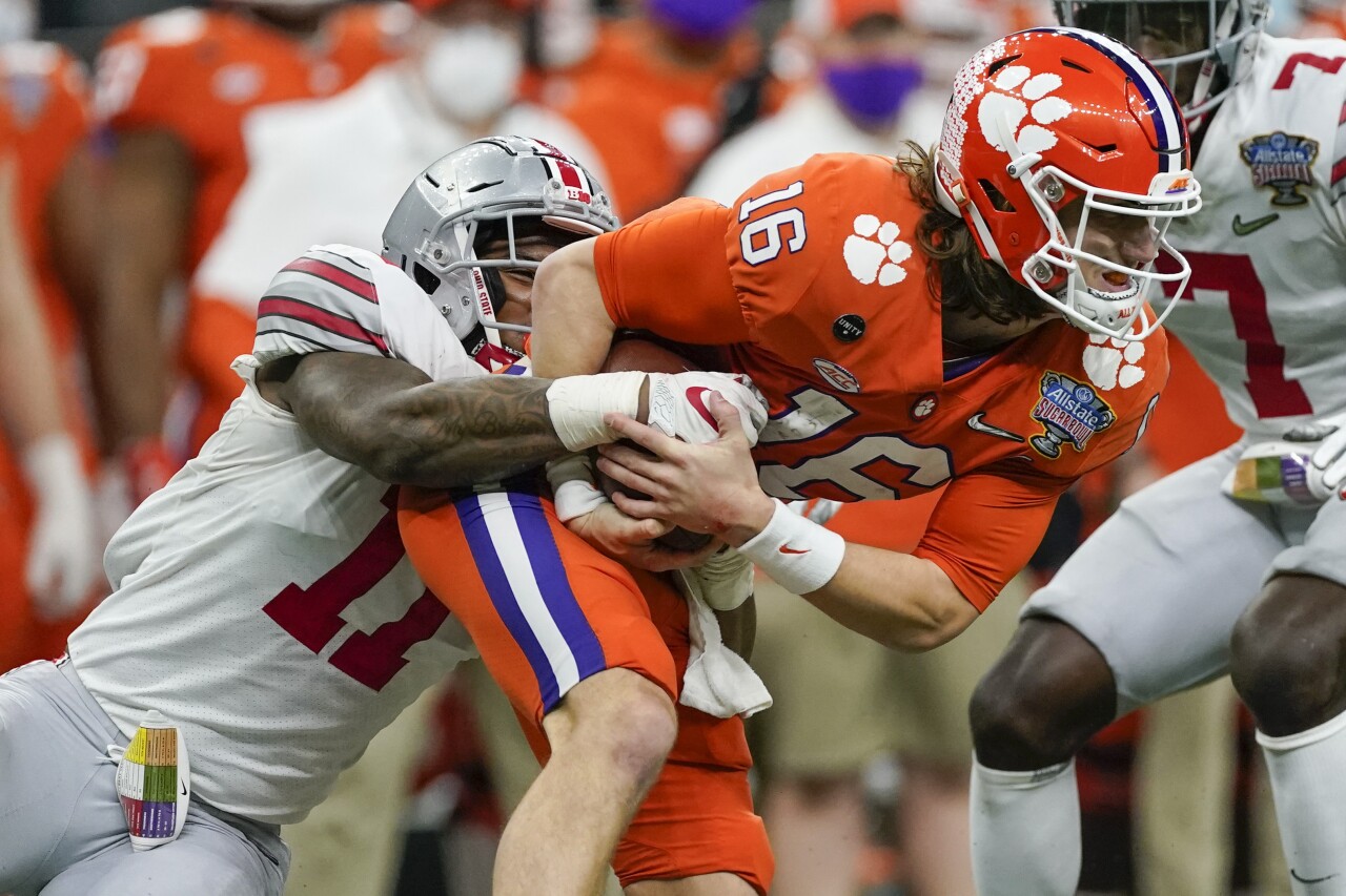 Clemson Tigers QB Trevor Lawrence tackled by Ohio State Buckeyes defensive end Tyreke Smith in College Football Playoff semifinal at Sugar Bowl