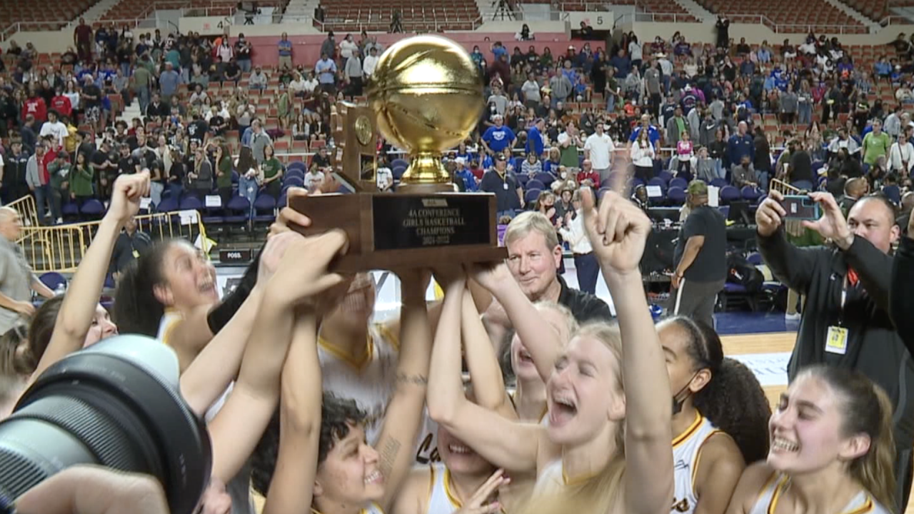 Salpointe girls basketball celebrates with a state championship trophy after beating Flagstaff in Monday's final in Phoenix.