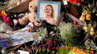 Flowers and photos are left at a memorial site for Renee Good on Saturday, Jan. 31, 2026, in Minneapolis.