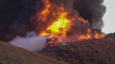 A bulldozer works to build a fire line on wildfire in Castaic, California.