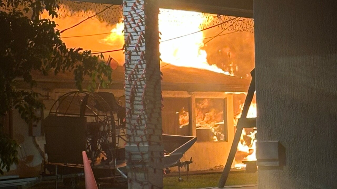 A ground view of the roof on fire at the Miccosukee Tiger Camp.