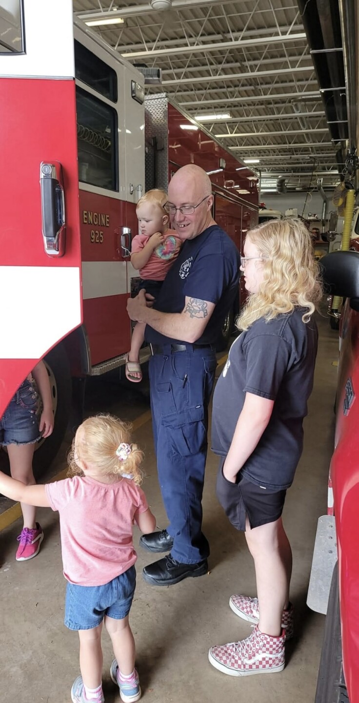 Jason Martin showing off a fire engine with his nieces.