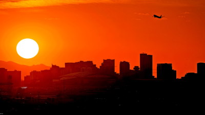 A jet takes flight from Sky Harbor International Airport as the sun sets over Phoenix.