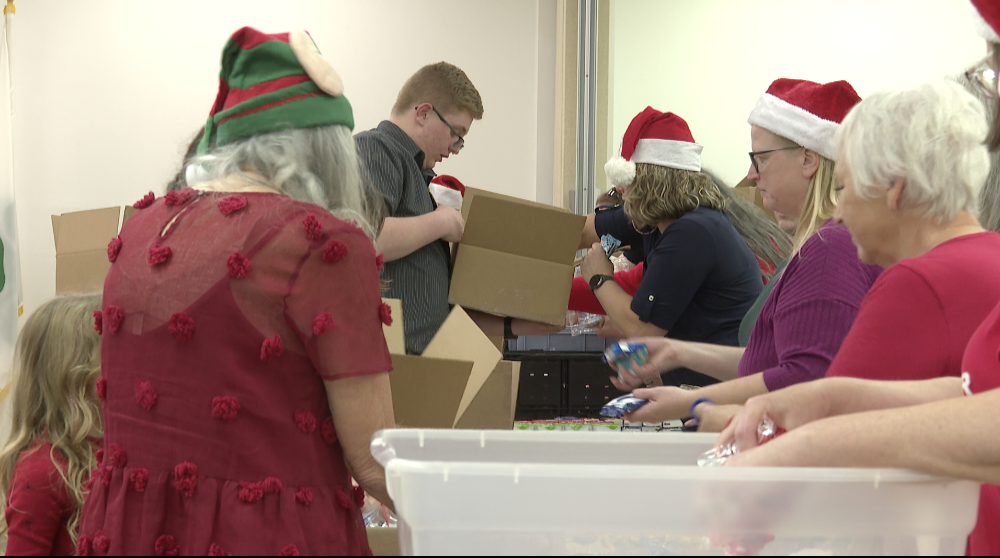 Students in assembly line filling their Christmas stockings