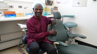 Dr. Richardson by a dental chair
