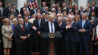 House Republicans surrounding President Donald Trump