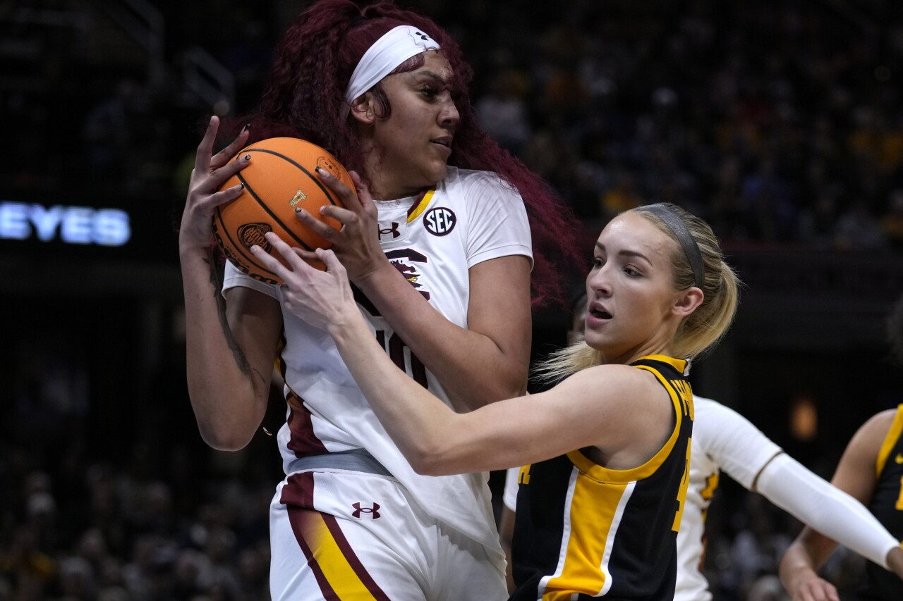 South Carolina Gamecocks center Kamilla Cardoso grabs rebound over Iowa Hawkeyes guard Kylie Feuerbach in national championship, April 7, 2024