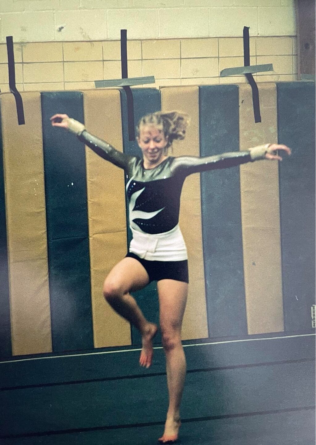 Moore performing gymnastics in high school