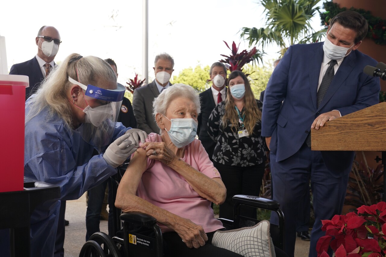 Gov. Ron DeSantis watches as nurse administers COVID-19 vaccine to Vera Leip in Pompano Beach, Dec. 16, 2020