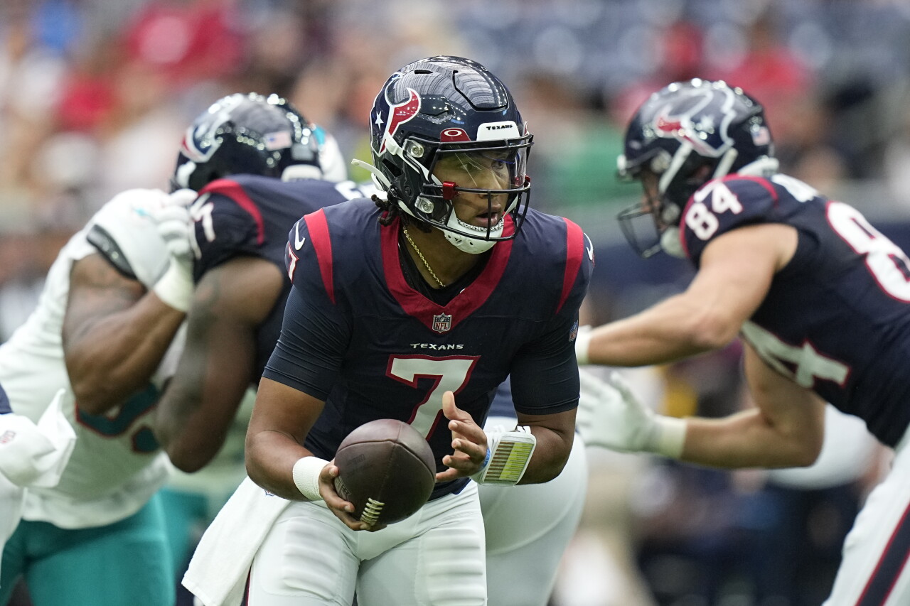 Houston Texans QB C.J. Stroud hands off football during preseason game vs. Miami Dolphins, Aug. 19, 2023