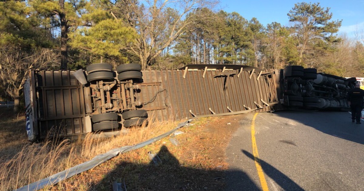 Driver injured, charged after tractor trailer overturns on I-95