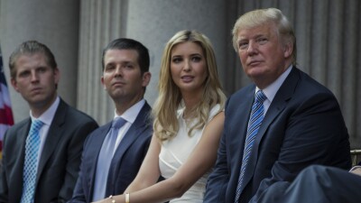 Donald Trump, right, sits with his children, from left, Eric Trump, Donald Trump Jr., and Ivanka Trump.