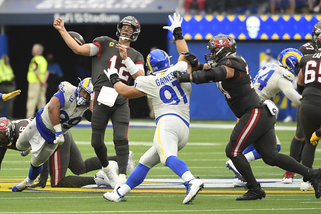 Tampa Bay Buccaneers QB Tom Brady loses football under pressure from Los Angeles Rams defensive end Aaron Donald, Sept. 26, 2021