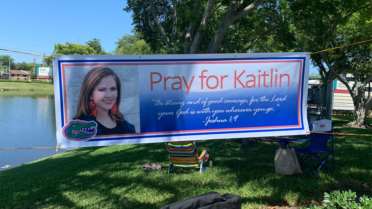 Kaitlin Alexander's parents have set up a tent and banner outside Delray Beach Medical Center where their daughter is being treated. 