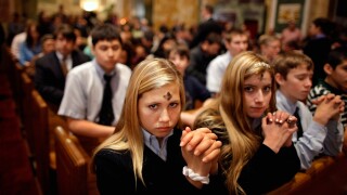Catholics pray during an Ash Wednesday Mass.