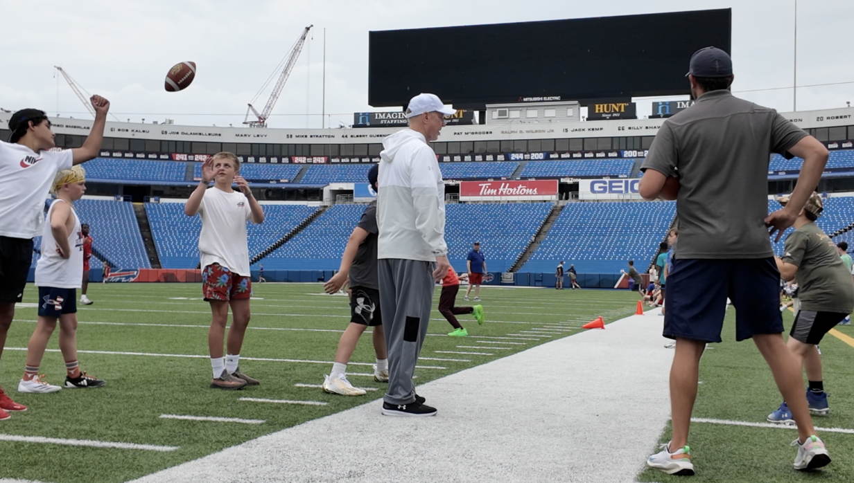 Jim Kelly working out with kids at annual camp