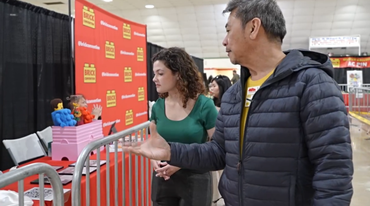 23ABC's Neighborhood Reporter Avery Elowitt getting a tour of the Lego displays with Amado Pinlac, one of the artists