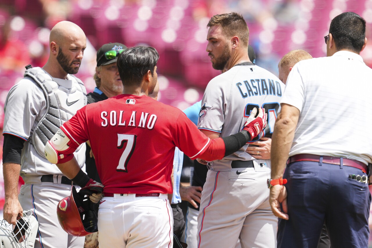 Cincinnati Reds second baseman Donovan Solano speaks with Miami Marlins starting pitcher Daniel Castano after hitting him in head, July 28, 2022