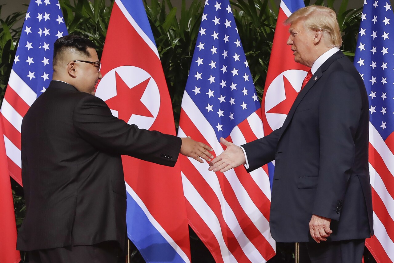 President Donald Trump and Kim Jong Un shake hands, June 12, 2018