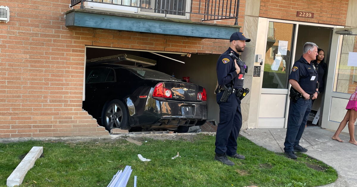 Car crashes into apartment in Cleveland, pinning 2 people inside