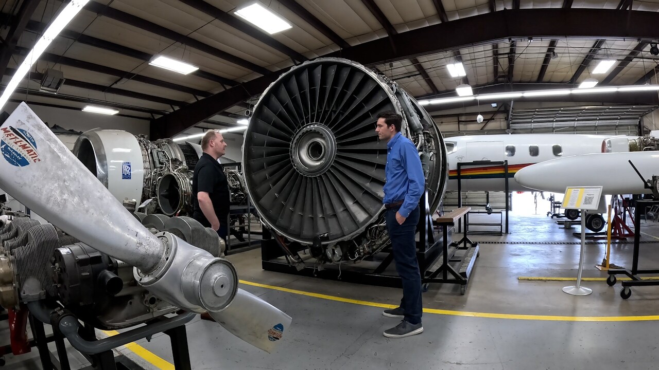Damian Hallam, Program Chair of Spartan College's aircraft maintenance technician program (left) stands with Denver7's Ryan Fish (right) inside a hangar at the school's Broomfield campus.