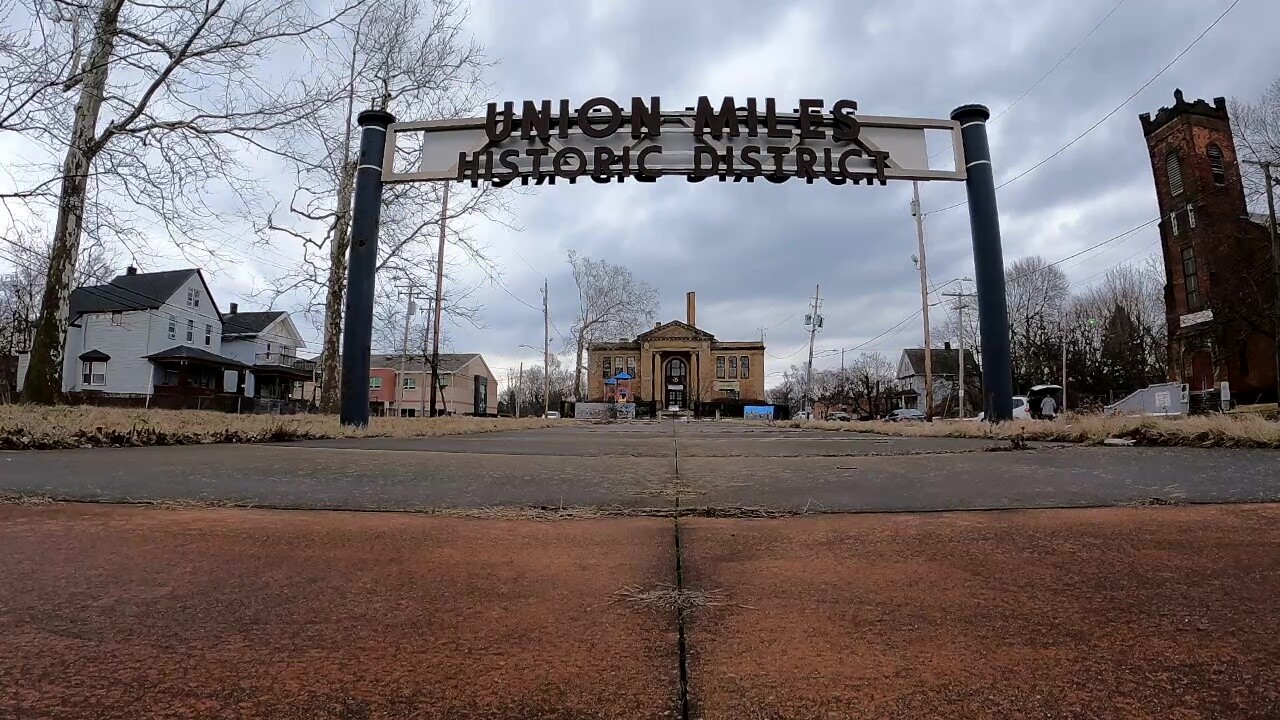 A sign on the central green identifies the historic district, a former village square in the Union-Miles neighborhood.