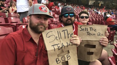 reds fans wear brown paper bags to game