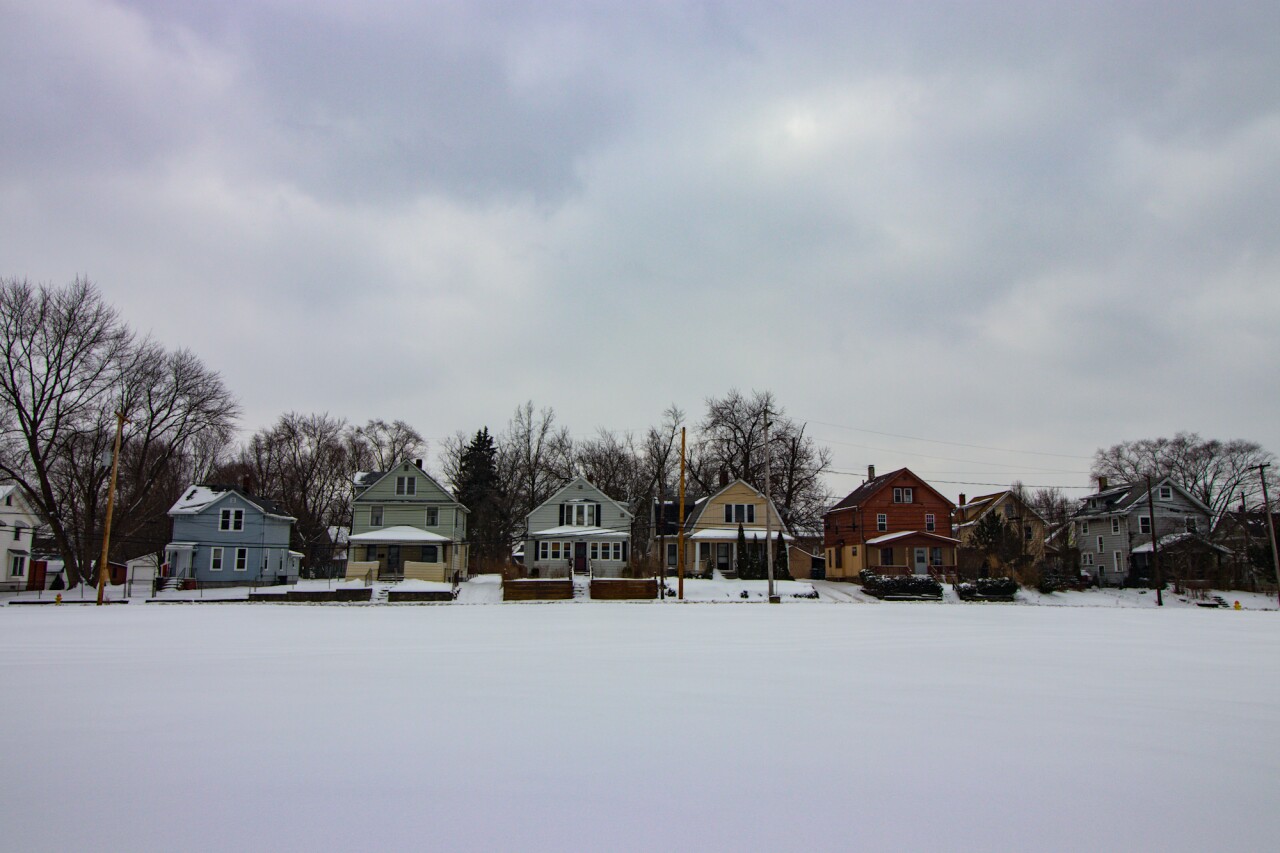 A row of homes on Corley Street sit opposite the former site of Mason Elementary School, now an empty field. (H.L. Comeriato).jpg