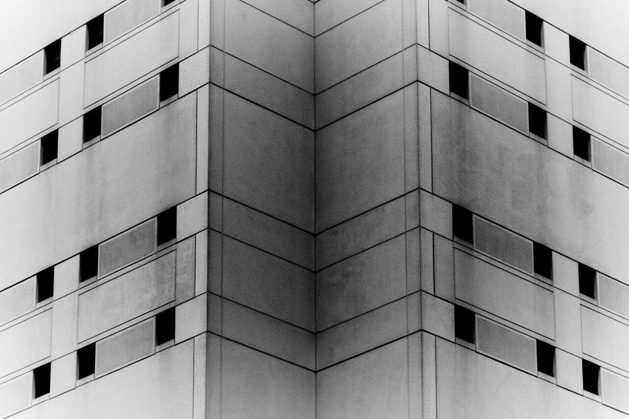 A zoomed in black and white photo shows windows on two sides of the Cuyahoga County Jail.