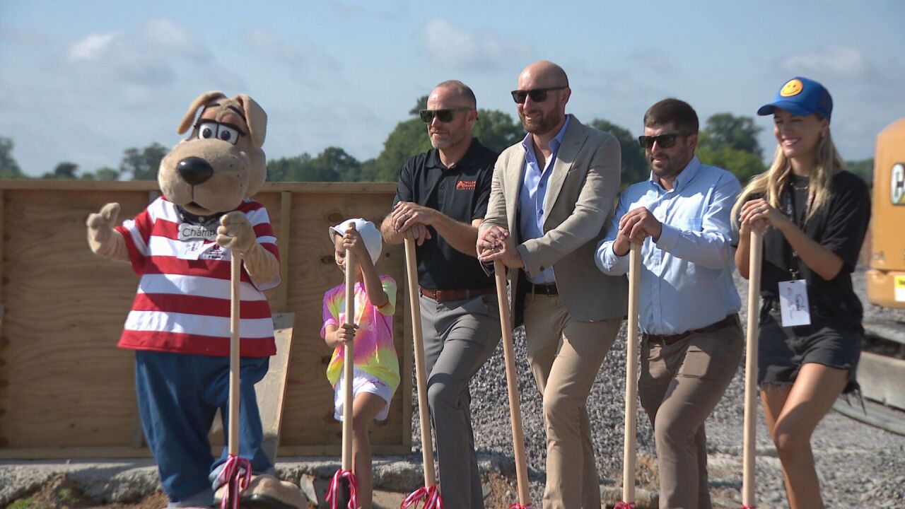 Champ the mascot and several nonprofit reps break ground on I Am Home house for raffle