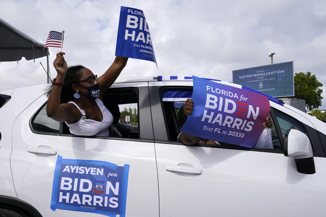 Supporters attend drive-in rally for former President Barack Obama in North Miami, Oct. 24, 2020