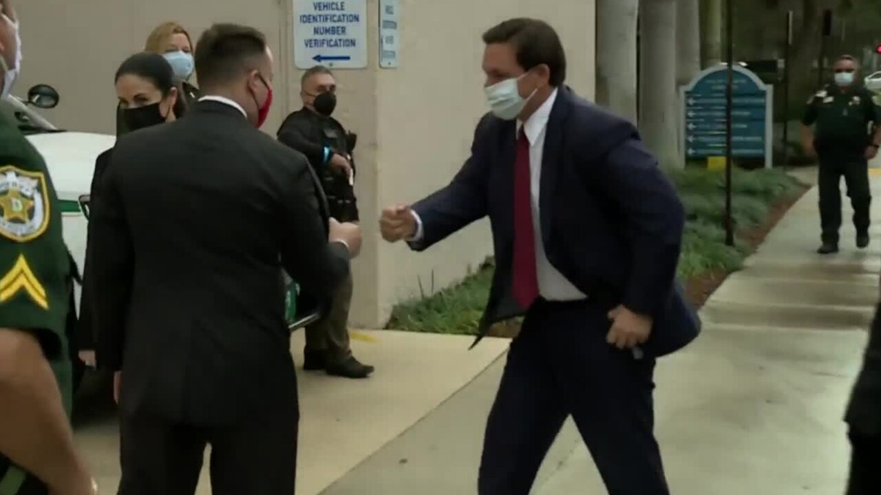Gov. Ron DeSantis gives fist bump to Palm Beach County Mayor Dave Kerner, Jan. 12, 2021