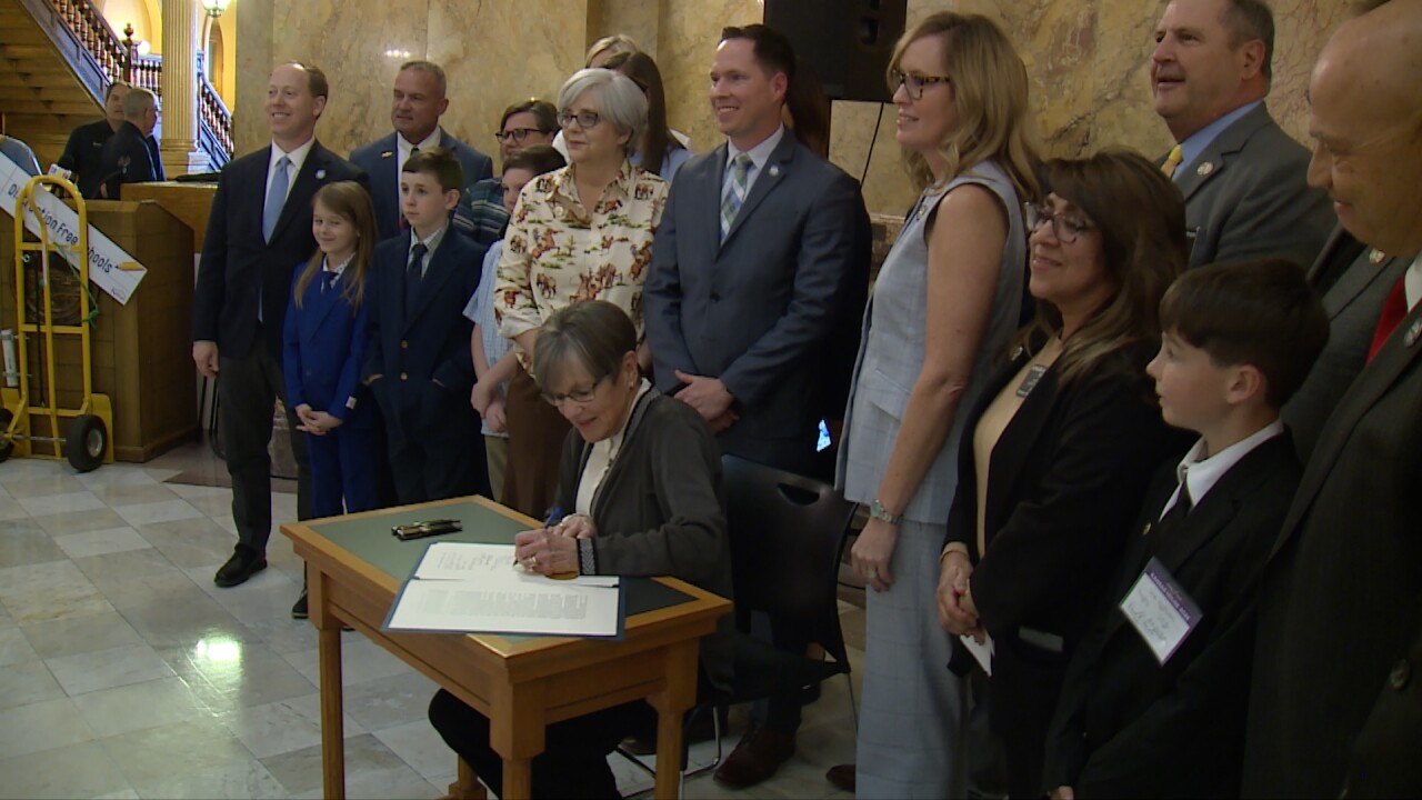 Gov Kelly signs bill.jpg