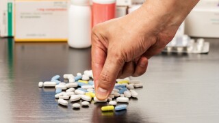 Cropped,Shot,Of,A,Man,Hand,Catching,A,Pill,From