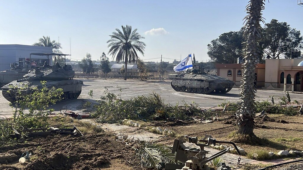 A tank with an Israeli flag enters the Gazan side of the Rafah border crossing.